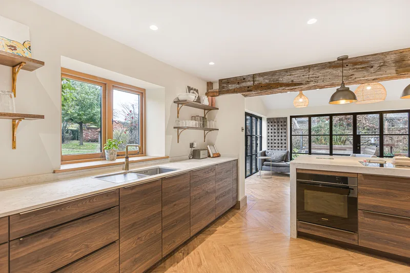 Walnut cabinetry and pale worktop in the Barn Conversion